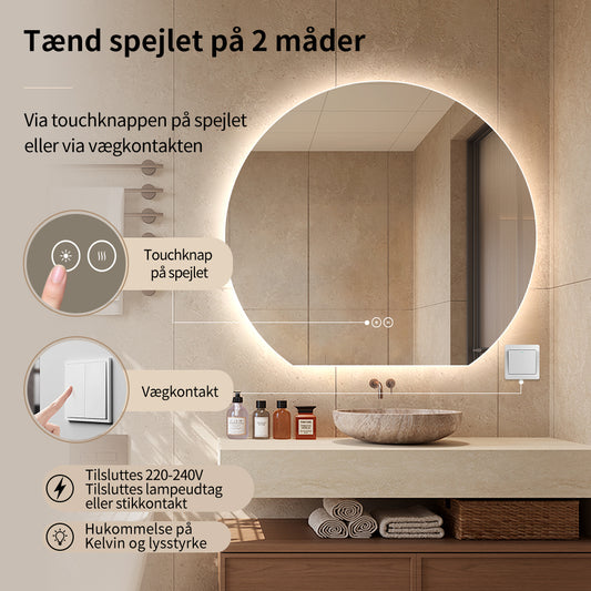 Rundt spejl skåret i bunden med LED-lys og antidug Ø120 cm tændt over håndvask i sten på lyst badeværelse